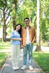 Photo of young Asian couple at park