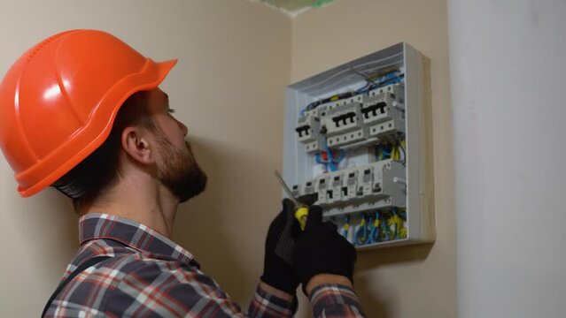 Professional Electrician Installing Electrical Panel