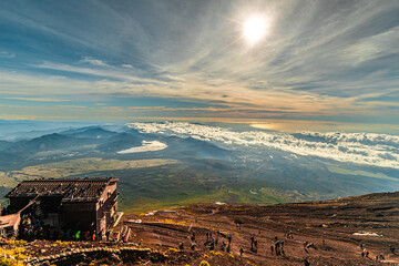 wooden hut and group of people hiking in the mountain