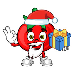 Tomato fruit santa cartoon character holding a gift