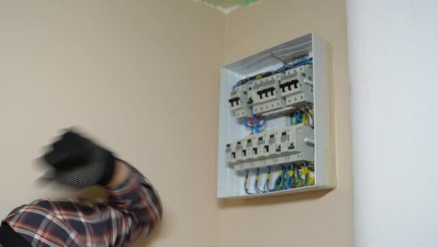 Professional Electrician Installing Electrical Panel. Electric shock