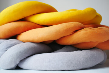 stack of Colorful pillows ion bed 