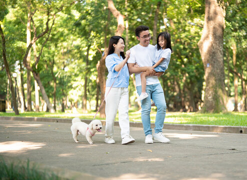 Photo of young Asian family at park