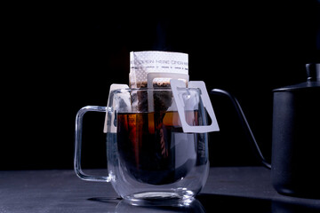 Drip coffee and pour water on the black stone table, soft focus.shallow focus effect.