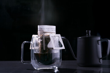 Drip coffee and pour water on the black stone table, soft focus.shallow focus effect.