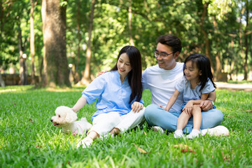 Fototapeta premium Photo of young Asian family at park