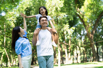 Naklejka premium Photo of young Asian family at park