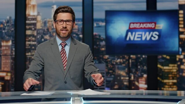 Smiling newscaster reporting business information in studio. Anchor man talking