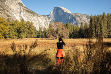 Hiker taking picture of Half Dome in Yosemite Valley, Yosemite National Park, California