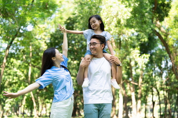 Photo of young Asian family at park