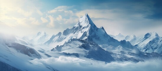 Obraz premium The snow covered mountain peak offers a breathtaking view of the winter landscape showcasing the beauty of nature and making it a perfect destination for outdoor enthusiasts seeking to trave