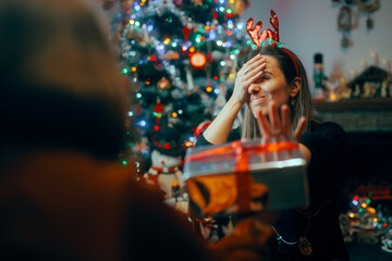 Ungrateful Woman Refusing a Christmas Gift from a Friend. Rude holiday party host rejecting...