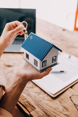 Real estate broker agent presenting and consult to customer to decision making sign insurance form agreement, buy and sell home model, concerning mortgage loan offer for and house insurance