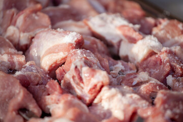 Cut fresh beef meat with salt for mtsvadi, shashlik