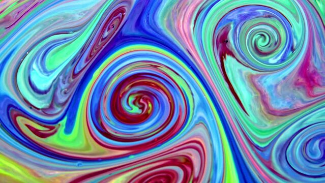 This stock video features a colored oil mixture that has been added with milk. The milk lets the colorful liquid spread out and form new colors and figures. 
