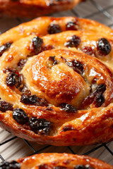 Pain aux raisins, also called escargot or pain russe, is a spiral pastry often eaten for breakfast in France. Its names translate as raisin bread, snail, and Russian bread respectively. - obrazy, fototapety, plakaty