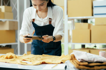 Fototapeta premium Online sellers use mobile phone to take pictures of product sent to customers..