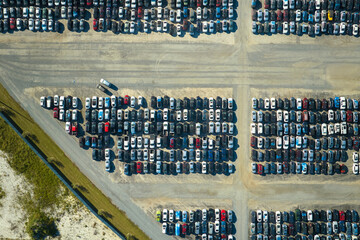 Aerial view of auction reseller company big parking lot with parked cars ready for remarketing services. Sales of secondhand vehicles
