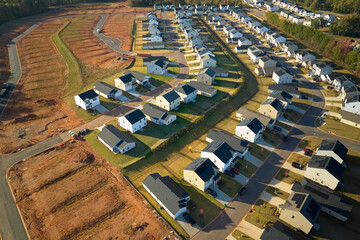 Aerial view of construction site with new tightly packed homes in South Carolina. Family houses as...