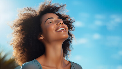 A African woman breathes calmly looking up isolated on clear blue sky - Powered by Adobe