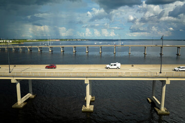Barron Collier Bridge and Gilchrist Bridge in Florida with moving traffic. Transportation...