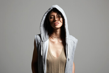 beautiful young woman in hood. girl in grey hoodie