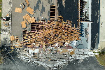 Hurricane Ian destroyed house roof and walls in Florida residential area. Natural disaster and its...