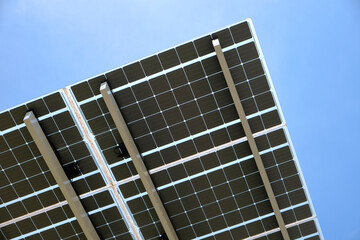 Fototapeta premium Solar photovoltaic panels mounted on metal frame for producing clean ecological electric energy. Renewable electricity with zero emission concept