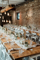 Wedding decoration with flowers and wooden tables and chairs in pastel colors 