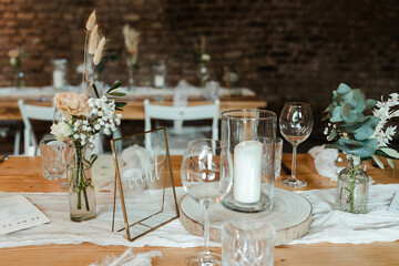 Wedding decoration with flowers and wooden tables and chairs in pastel colors 