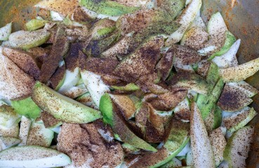 Raw Mango Cuts Marinated with Salt, Red Chili Powder, Black Pepper Powder and Turmeric Preparing for Mango Pickle