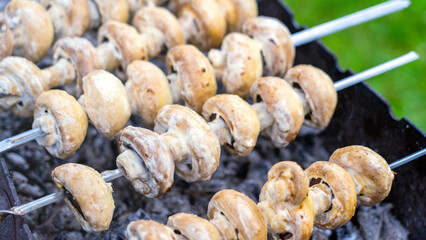 large mushrooms on the grill, cooking mushrooms on the barbecue, cooking outside in the backyard.