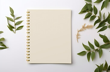 Eucalyptus branches with leaves and blank card on white background. Blank notebook and christmas decorations on white background. Flat lay, top view. Flat lay of blank notebook sheet with copy space