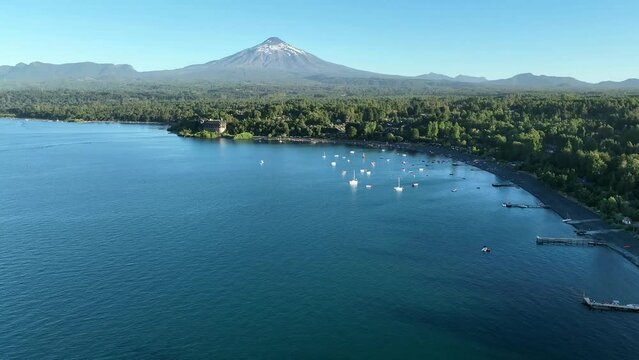 Aerial Dolly over Villarrica Lake Hotel Bay to the Volcano, Chile