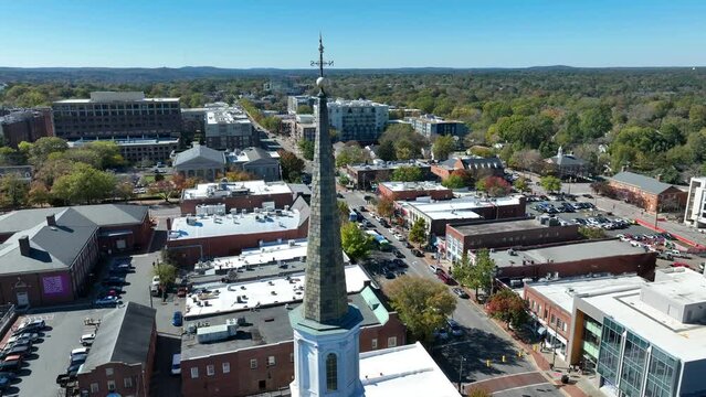 Chapel Hill, North Carolina aerial establishing shot. Orbit around church steeple on main street in college town in USA.