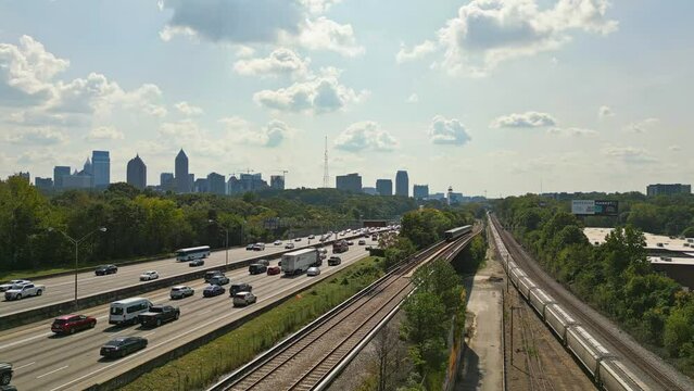 Aerial view of skyline of Atlanta in Background and busy highway with Passing train