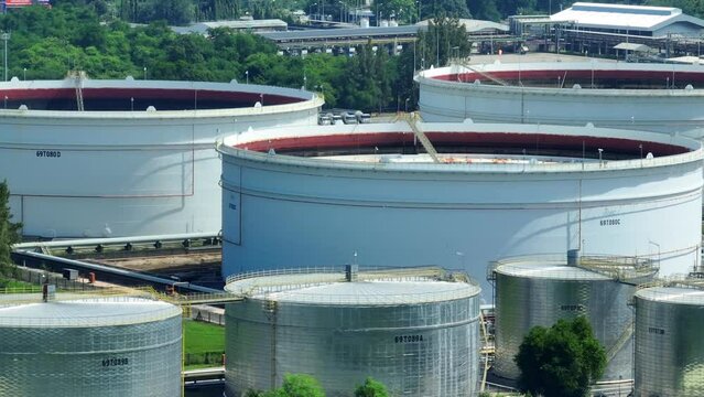 Oil depots and refineries, industrial titans on the economic chessboard, stand as sentinels of energy's cost and availability. A drone's perspective underscores their strategic importance.
