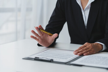 Businessman holding a pen to sign a contract, making a detailed agreement, business contract for finance, real estate, insurance, taxes and signing an official document.