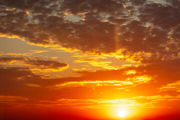 Golden sunset on the sky with clouds