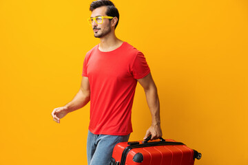 Man trip baggage travel vacation flight suitcase journey happy traveler studio yellow background