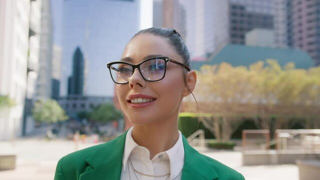 Close-up portrait of nice-looking businessperson with beautiful makeup. Elegant young woman looking into camera in downtown on motion background. Career smart people. Fashion, beauty. Female portraits