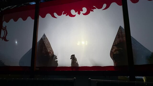 Silhouette of wayang kulit or shadow puppets from Java, Indonesia. Traditional puppet show by puppeteer