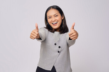 Smiling happy beautiful young Asian woman in casual clothes showing thumbs up or like isolated on white background. People lifestyle emotion concept