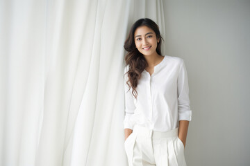 Young indian woman in white shirt and pant - obrazy, fototapety, plakaty