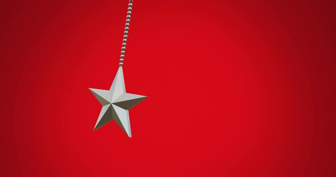 Animation of hanging star swinging against red background