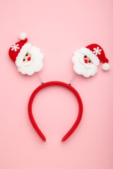 Christmas headband Santa Claus head design on pink background.