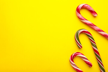 Christmas candy cane on yellow background. Top view