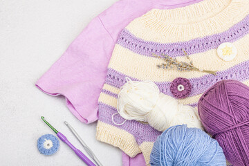 Handmade crocheted baby t-shirt in lilac tones. Stuff contains thread, hooks, knitting needles