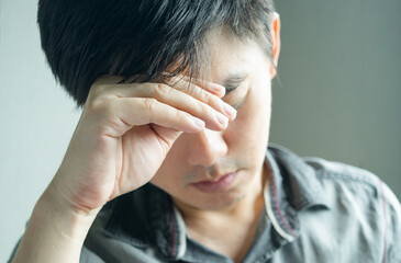 Fototapeta premium Man has a headache and stress His face was not happy. Causes of working hard and not getting enough rest