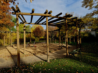 the high structure of the pergola turns into a circle, in the middle there is a sandpit for...